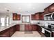 Spacious kitchen boasts granite countertops and stainless steel appliances at 18351 W Southgate Ave, Goodyear, AZ 85338