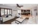 Open concept living room showcases a smooth flow into the kitchen with lovely ceiling fan at 18351 W Southgate Ave, Goodyear, AZ 85338