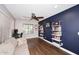 Comfortable home office with a dark accent wall and a modern shelving unit at 18351 W Southgate Ave, Goodyear, AZ 85338