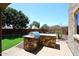 Outdoor kitchen featuring stone accents, built-in grill, and granite countertop at 18351 W Southgate Ave, Goodyear, AZ 85338