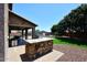 Backyard featuring an outdoor kitchen, covered patio, and pool at 18351 W Southgate Ave, Goodyear, AZ 85338