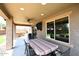Covered patio featuring outdoor seating, ceiling fan, and backyard views at 18351 W Southgate Ave, Goodyear, AZ 85338