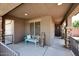 Cozy front porch with seating, stone accents, and a view of the entryway at 18351 W Southgate Ave, Goodyear, AZ 85338