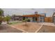 Spacious backyard with a covered patio, artificial turf, a built-in grill, and desert landscaping at 1861 N 63Rd Ave, Phoenix, AZ 85035
