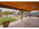 Backyard area with covered patio, firepit, seating, outdoor kitchen area, and lush landscaping for a relaxing outdoor space at 1861 N 63Rd Ave, Phoenix, AZ 85035