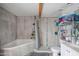 Bright bathroom featuring a soaking tub, tiled shower, and modern vanity for a comfortable and stylish experience at 1861 N 63Rd Ave, Phoenix, AZ 85035