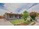 Charming single-story home showcasing a well-manicured front yard, covered patio, and inviting curb appeal at 1861 N 63Rd Ave, Phoenix, AZ 85035