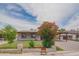 Well-maintained single-Gathering home with a manicured front yard, covered parking, blooming flowers, and a cozy aesthetic at 1861 N 63Rd Ave, Phoenix, AZ 85035