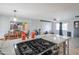 Open kitchen features a center island, modern appliances, and seamless flow to the dining and living areas at 1861 N 63Rd Ave, Phoenix, AZ 85035