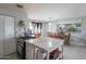 Bright kitchen with island gas range cooktop and breakfast bar with adjacent dining room, perfect for modern living at 1861 N 63Rd Ave, Phoenix, AZ 85035