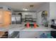 Bright kitchen featuring a waterfall island with seating and modern appliances, perfect for cooking and gathering at 1861 N 63Rd Ave, Phoenix, AZ 85035