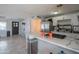 Bright kitchen featuring a waterfall island with seating and modern appliances, perfect for cooking and gathering at 1861 N 63Rd Ave, Phoenix, AZ 85035