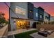 Modern home's backyard with sleek design, cozy seating around a fire pit, and beautiful outdoor lighting at 1910 W Desert Hollow Dr, Phoenix, AZ 85085