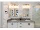 Elegant bathroom with double vanity, white marble, modern light fixtures and a glass shower at 1910 W Desert Hollow Dr, Phoenix, AZ 85085