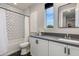 Modern bathroom featuring herringbone tile, sleek vanity, and a window with a view at 1910 W Desert Hollow Dr, Phoenix, AZ 85085
