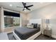 Bedroom featuring a dark color palette and bright lighting from the large window at 1910 W Desert Hollow Dr, Phoenix, AZ 85085