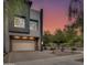 Contemporary home with a stone-accented garage and inviting curb appeal at dusk at 1910 W Desert Hollow Dr, Phoenix, AZ 85085