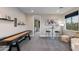Bright game room features a shuffleboard table, seating, and a view of the outdoor scenery at 1910 W Desert Hollow Dr, Phoenix, AZ 85085