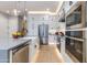 Modern kitchen featuring white cabinetry, stainless steel appliances, and a large island with a breakfast bar at 1910 W Desert Hollow Dr, Phoenix, AZ 85085