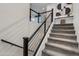Modern staircase with sleek metal railings and plush carpet, leading to the upper level at 1910 W Desert Hollow Dr, Phoenix, AZ 85085