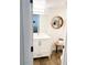 Bright bathroom featuring wood-look floors and a modern vanity with open shelving at 20 S Buena Vista Ave # 111, Gilbert, AZ 85296