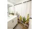 Bright bathroom featuring cactus themed shower curtain, a marble wall, and a modern vanity at 20 S Buena Vista Ave # 111, Gilbert, AZ 85296