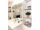 Contemporary bathroom featuring a spacious shower, modern vanity, and decorative shelving at 20 S Buena Vista Ave # 111, Gilbert, AZ 85296
