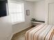 Serene bedroom featuring a window, built in bench, and comfortable bed with neutral tones at 20 S Buena Vista Ave # 111, Gilbert, AZ 85296