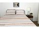Inviting bedroom with cozy bedding, accent pillows, and stylish bedside table with lamp at 20 S Buena Vista Ave # 111, Gilbert, AZ 85296