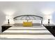 Cozy bedroom with iron frame bed and matching lamps on each nightstand at 20 S Buena Vista Ave # 111, Gilbert, AZ 85296