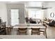Bright dining area features a white table with seating, seamlessly connecting to the open-concept living space at 20 S Buena Vista Ave # 111, Gilbert, AZ 85296