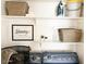 Well-organized laundry room with blue appliances and plenty of shelf space at 20 S Buena Vista Ave # 111, Gilbert, AZ 85296
