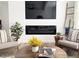 Comfortable living room featuring a fireplace, flat screen tv and stylish mid-century modern chairs and accessories at 20 S Buena Vista Ave # 111, Gilbert, AZ 85296