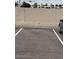 A parking lot with a designated parking space and privacy wall, offering convenient and secure parking at 20 S Buena Vista Ave # 111, Gilbert, AZ 85296