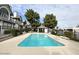 A community pool surrounded by lush green trees and well-maintained seating areas, creating a relaxing and inviting atmosphere at 20 S Buena Vista Ave # 111, Gilbert, AZ 85296