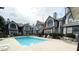 A community pool outside of white condos with seating area and staircase to upper units, perfect for relaxing and enjoying the weather at 20 S Buena Vista Ave # 111, Gilbert, AZ 85296