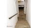 View down wood staircase to first floor leading to bedroom at 20 S Buena Vista Ave # 111, Gilbert, AZ 85296