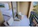 Relaxing balcony with cozy wicker chairs offers a glimpse into the bedroom and neighborhood views at 20750 N 87Th St # 2115, Scottsdale, AZ 85255
