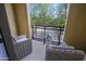 Outdoor balcony with wrought iron railing and cozy chairs overlook lush greenery and neighborhood at 20750 N 87Th St # 2115, Scottsdale, AZ 85255