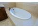 Elegant soaking tub with tile surround and bronze fixtures, offering a luxurious bathing experience at 20750 N 87Th St # 2115, Scottsdale, AZ 85255