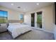 Bright bedroom featuring a large bed, neutral tones, and balcony access at 20750 N 87Th St # 2115, Scottsdale, AZ 85255