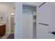 A linen closet with white painted drawers, cabinets, and shelves is conveniently located next to the sink and toilet at 20750 N 87Th St # 2115, Scottsdale, AZ 85255