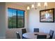 Cozy dining space with modern lighting and a large window with a picturesque mountain view at 20750 N 87Th St # 2115, Scottsdale, AZ 85255