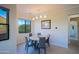 Bright dining area featuring modern lighting, a round table, and a large window showcasing the scenery at 20750 N 87Th St # 2115, Scottsdale, AZ 85255