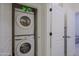 Modern stacked laundry machines in a small closet at 20750 N 87Th St # 2115, Scottsdale, AZ 85255