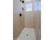 A tile shower provides a clean and modern look in a tiled walk-in enclosure with a small window and bronze-colored fixtures at 20750 N 87Th St # 2115, Scottsdale, AZ 85255