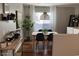 Bright dining room featuring a modern light fixture, dining set, and contemporary design elements at 2150 E Bell Rd # 1068, Phoenix, AZ 85022