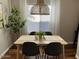 Bright dining room with a modern light fixture over a table with gray chairs and hardwood floors at 2150 E Bell Rd # 1068, Phoenix, AZ 85022