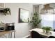 Dining area with a modern light fixture, table with green centerpiece, and a stylish coffee bar at 2150 E Bell Rd # 1068, Phoenix, AZ 85022