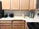 Kitchen features light wood cabinets, stone countertop, and stainless steel appliances at 2150 E Bell Rd # 1068, Phoenix, AZ 85022